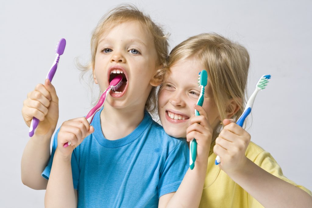 Kids with toothbrushes